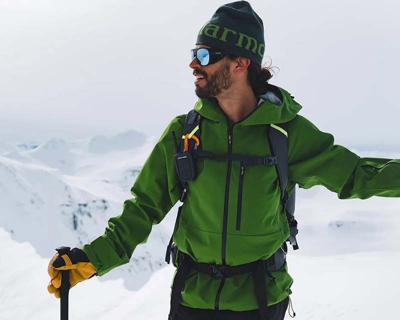man in outdoor clothing enjoying a hike through the mountains