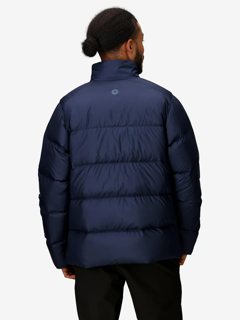 Man wearing a navy blue puffer jacket with quilted design, warm winter outerwear for cold weather