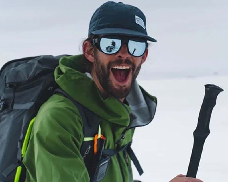 man in outdoor clothing enjoying a hike in the mountains