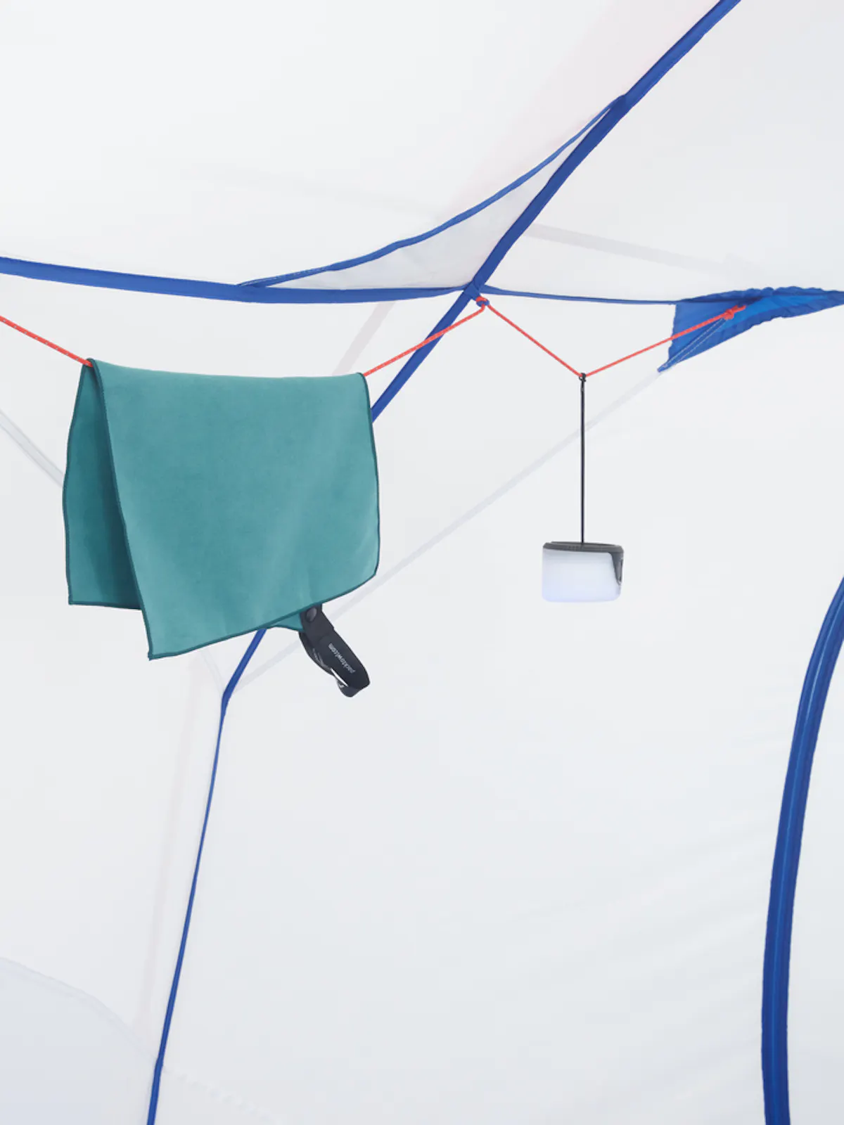 a clothesline inside of tent, with things hanging off of it