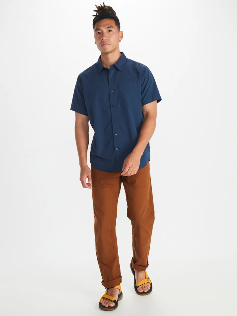 model wearing blue short sleeved button up shirt and brown pants