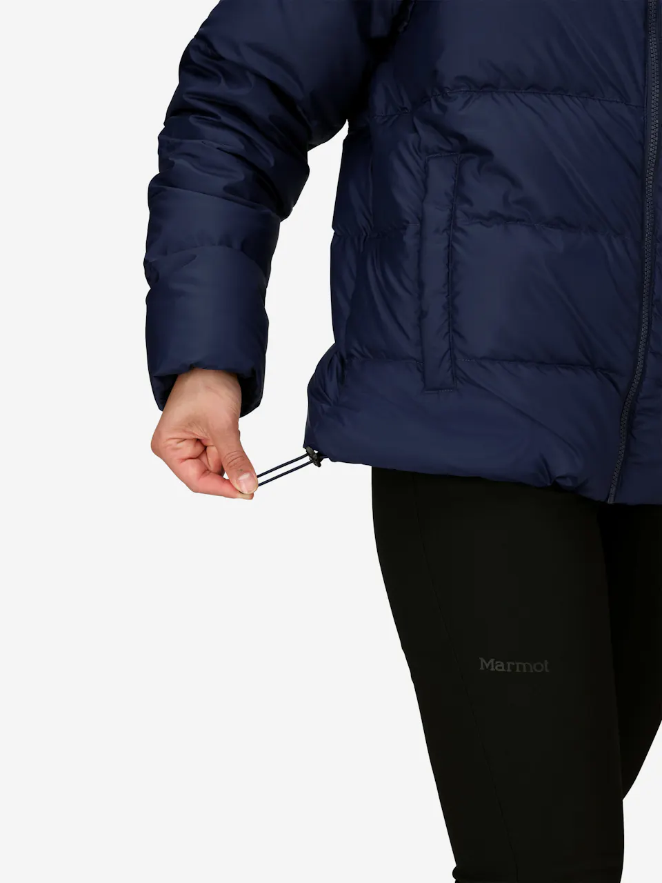 Woman adjusts drawstring hem on a blue insulated puffer jacket, perfect for winter outdoor activities