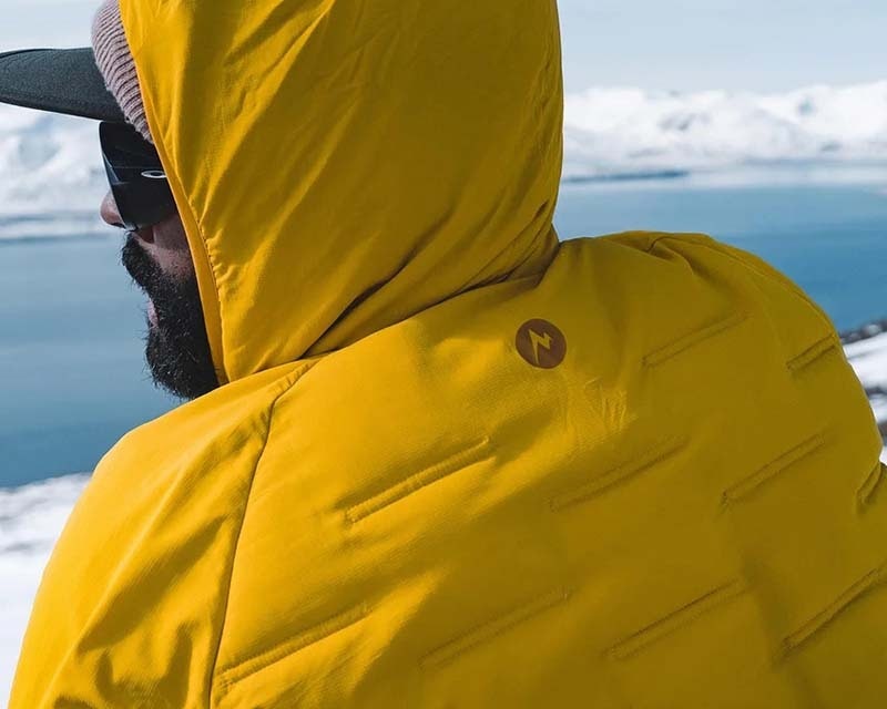 man in outdoor clothing enjoying a hike through the mountains