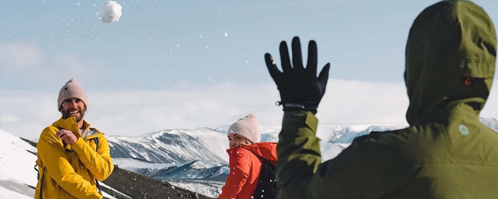 group of friends throwing snowballs at each other