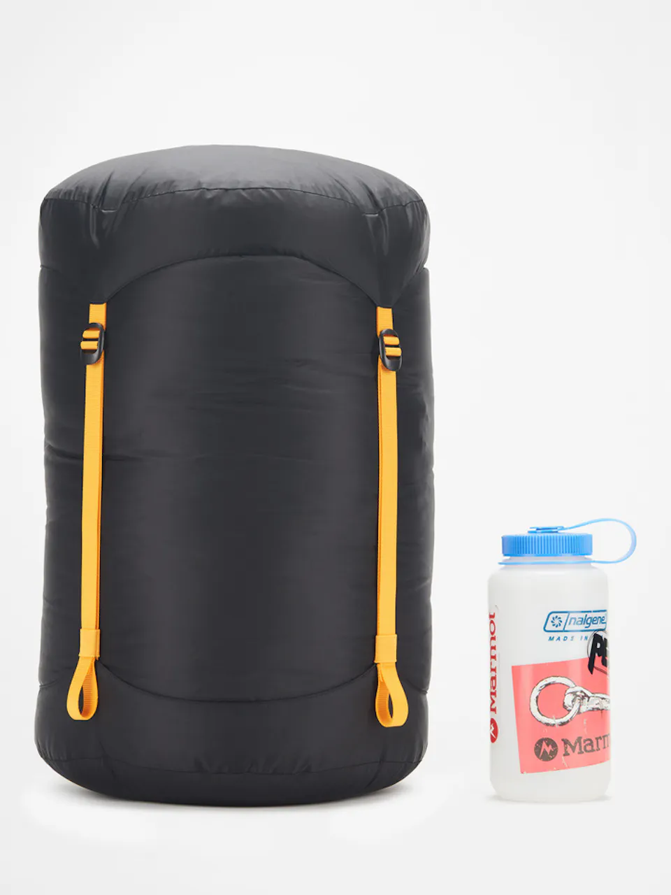 sleeping bag packed away in bag next to beverage container