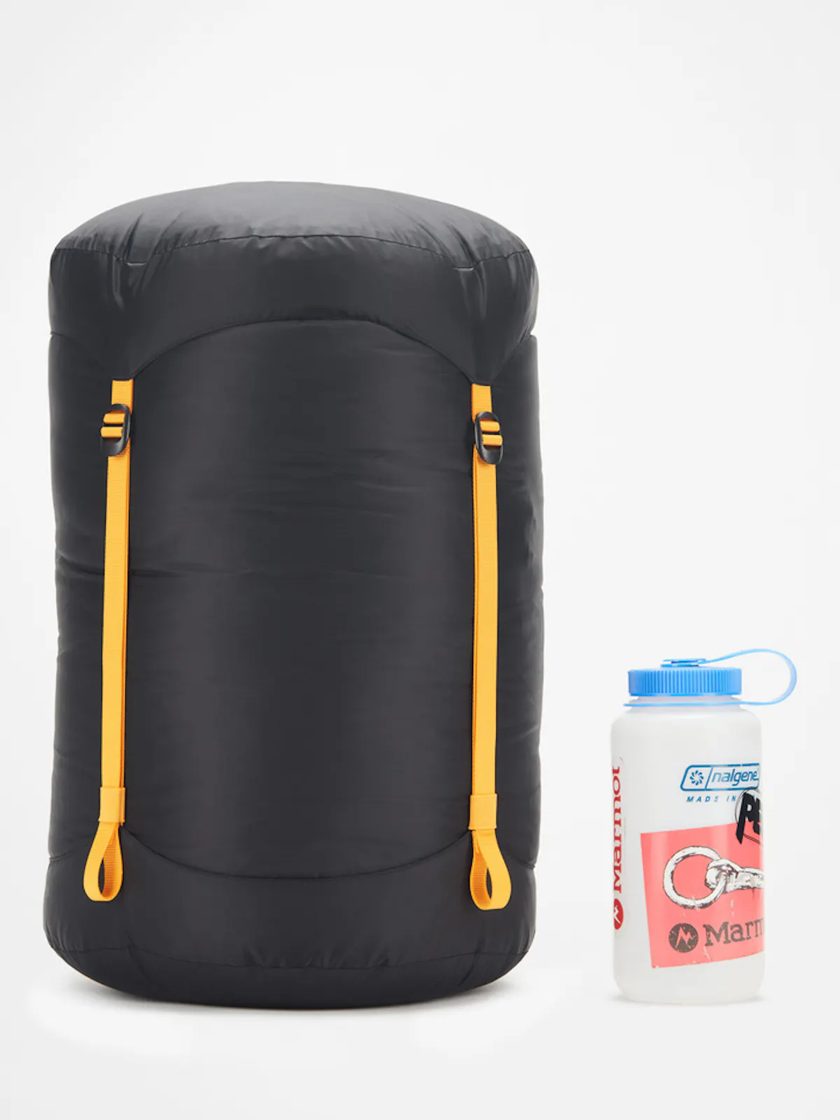 sleeping bag packed away in bag next to beverage container
