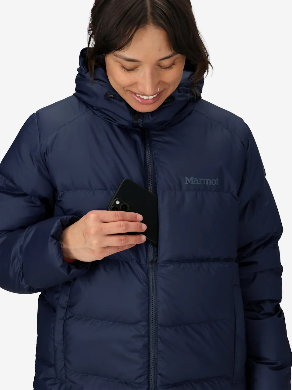 Warm puffer jacket with hood and zipper, features insulated quilted design, person holding smartphone.