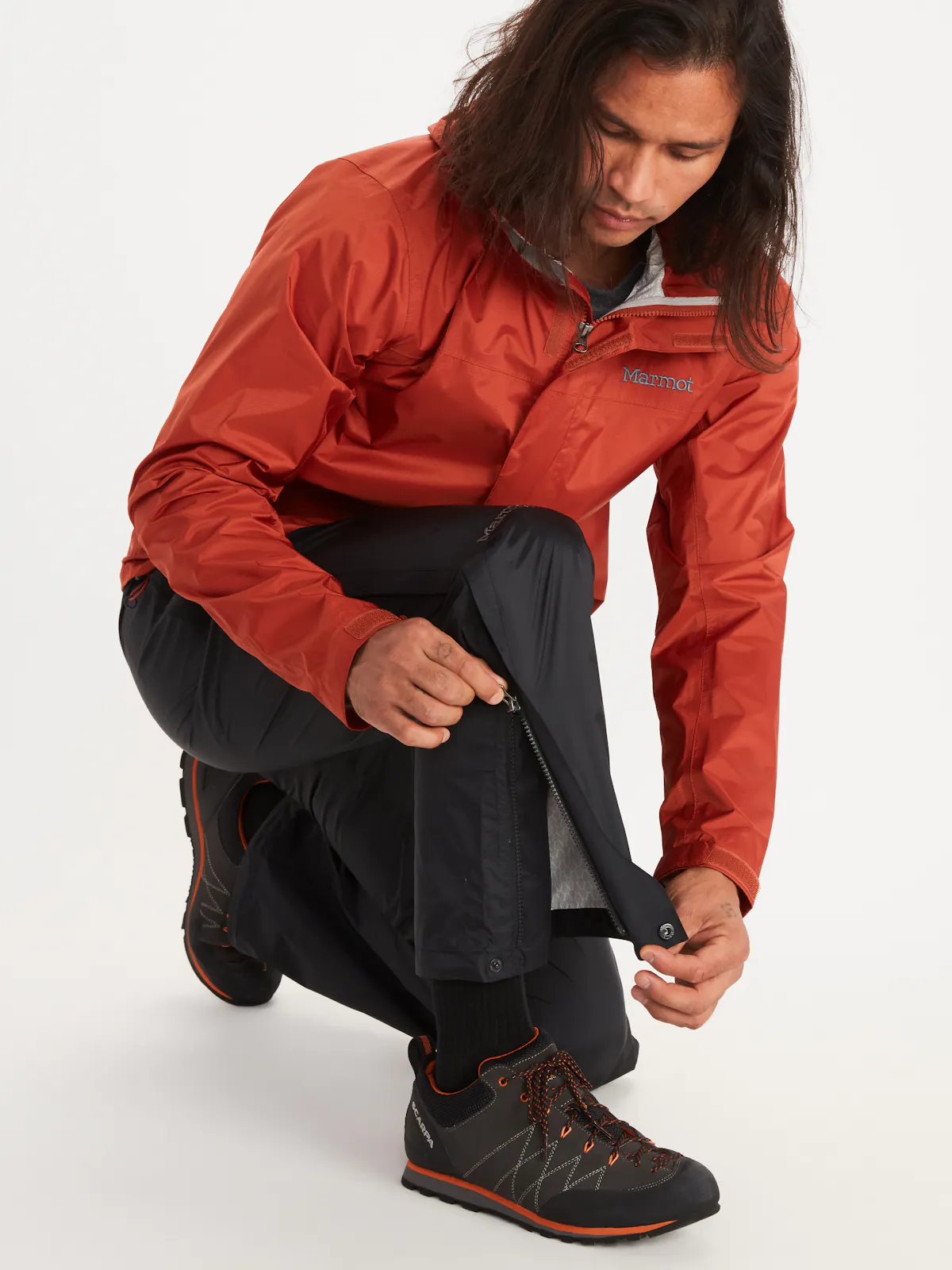 man unzipping pant leg