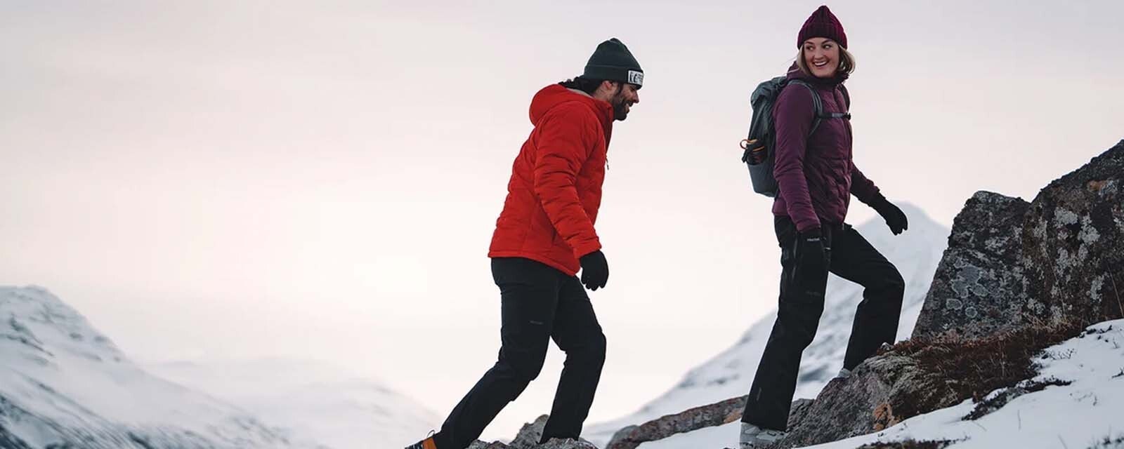 group of friends in outdoor gear enjoying a mountain hike